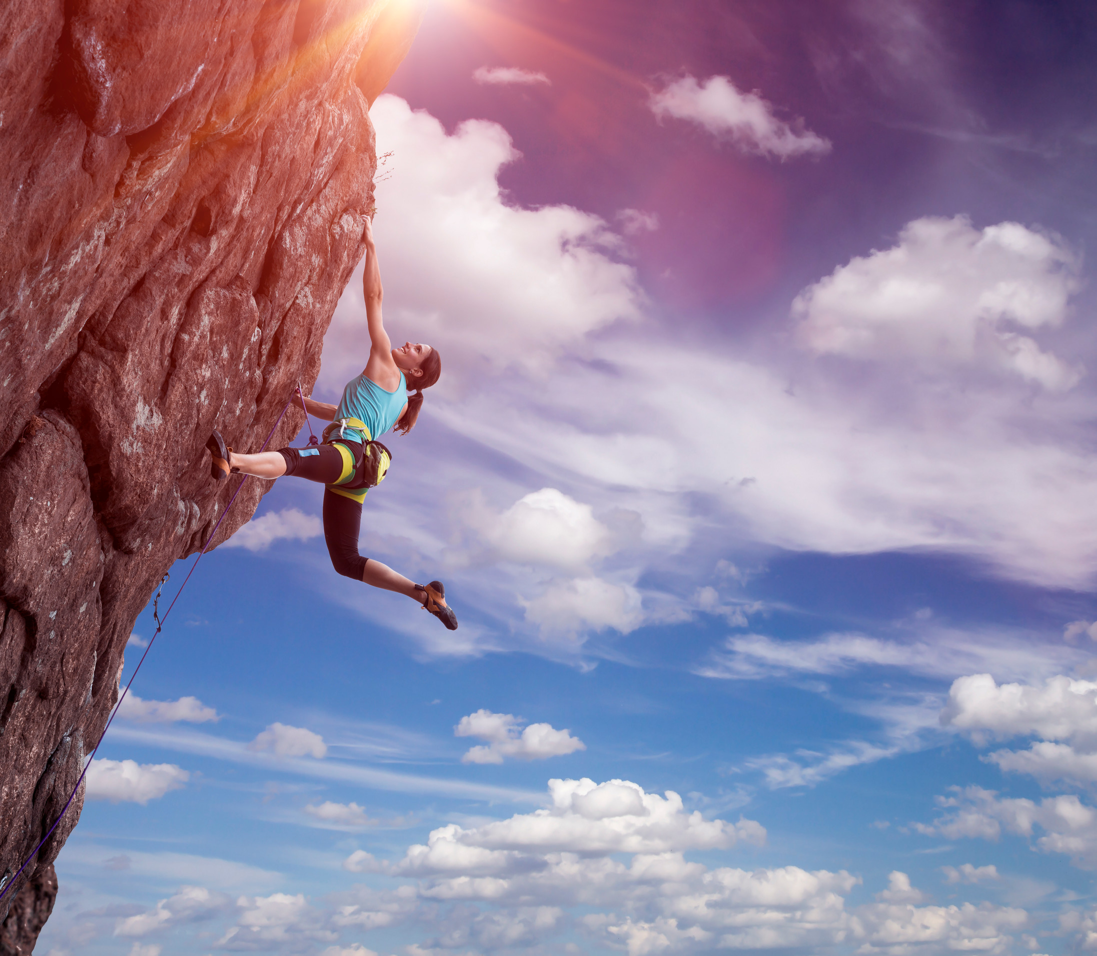 Climber hanging on her hand