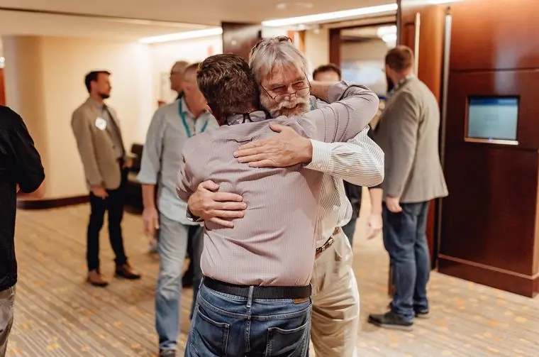 Freedom Founders members greeting each other warmly